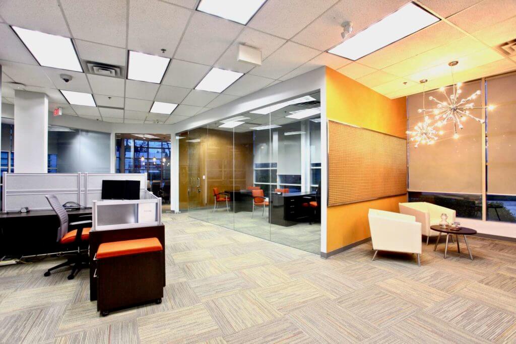 Modern office interior with glass partition, reception area with sputnik chandeliers,