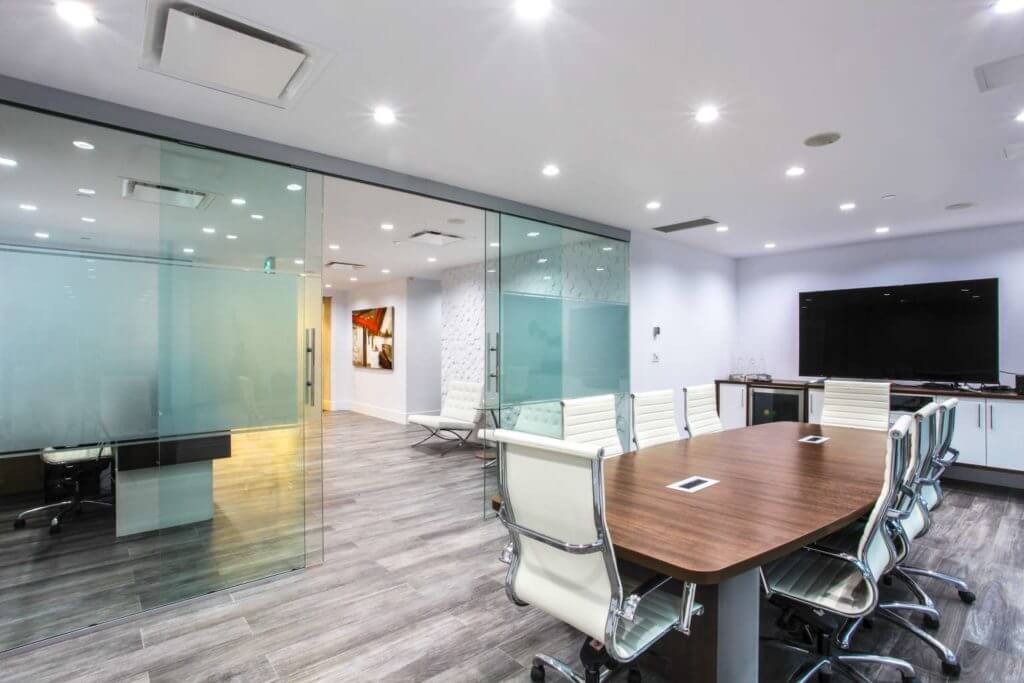 Modern corporate office boardroom with sliding glass door system.