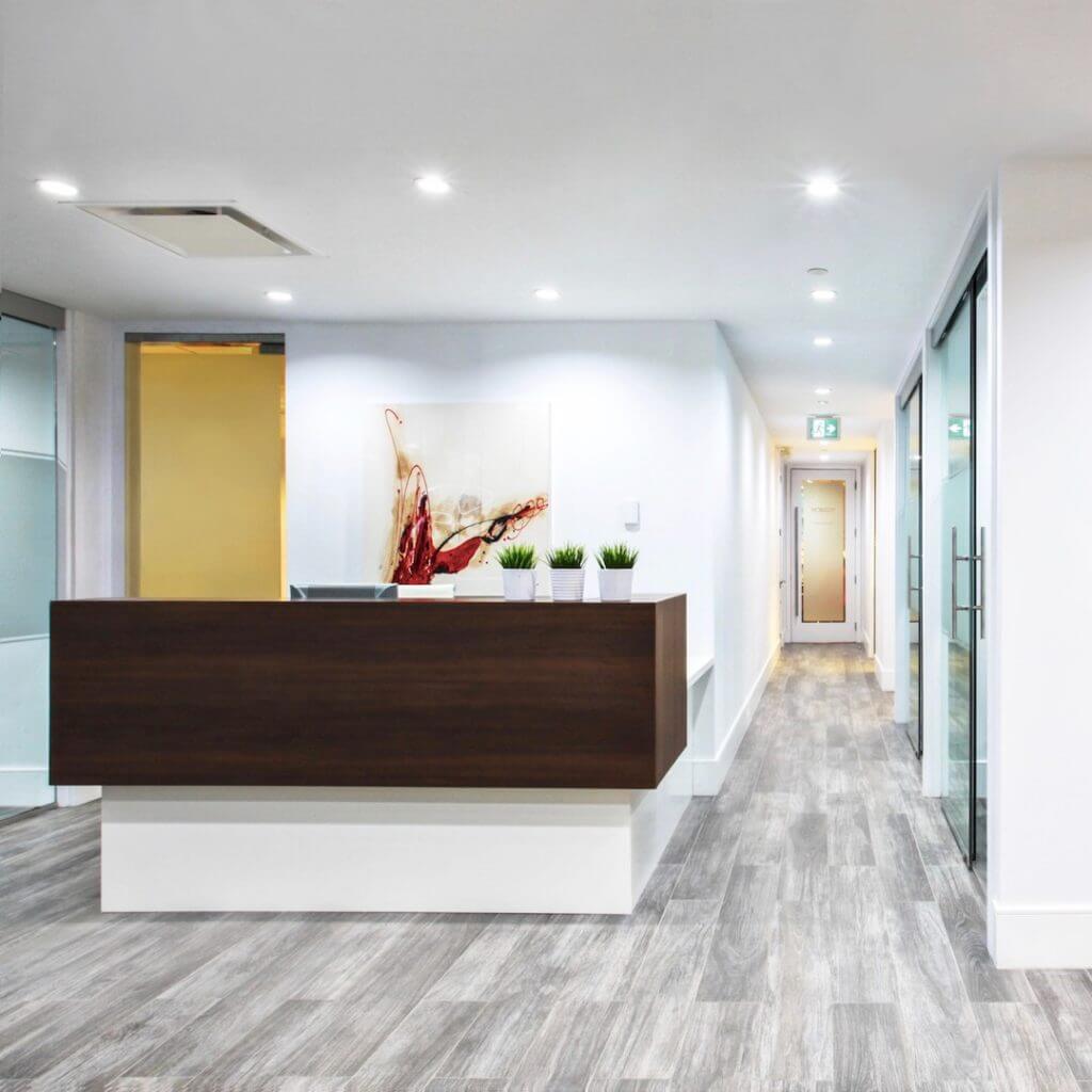 Custom reception desk in a modern corporate office in Vancouver.