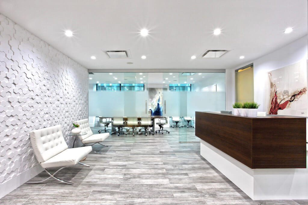 Modern reception area with textured feature wall and built-in reception desk.