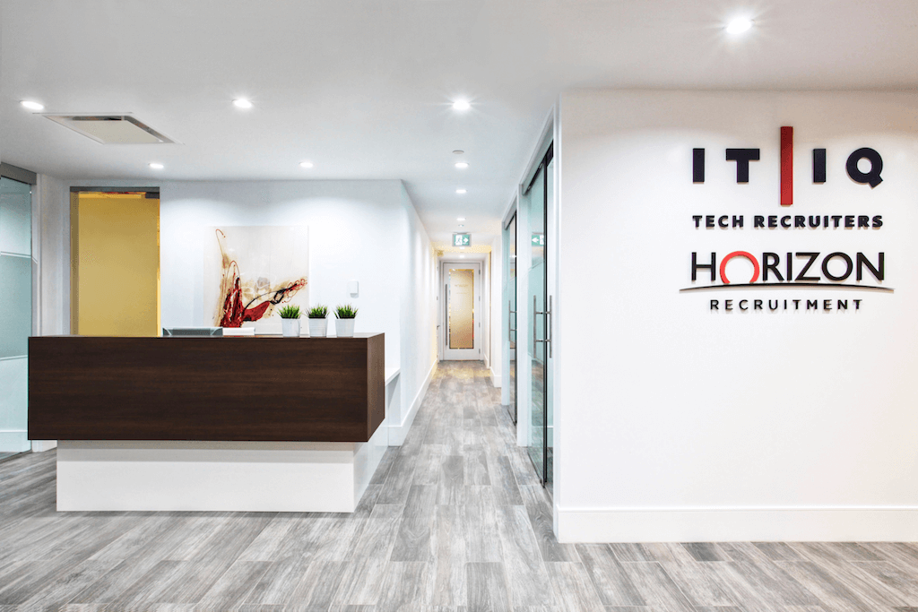 Modern reception area of a corporate office with built-in desk.